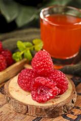 Fresh Red Raspberries on Wood Slice with Orange Juice and Grapes Healthy Fruit Display