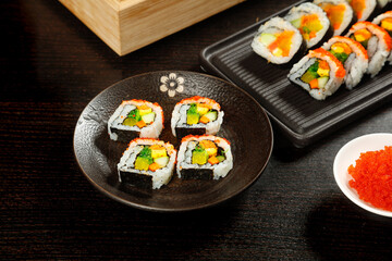 Delicate Japanese Sushi Rolls with Seaweed Rice Wrapping on Traditional Platter - Authentic Asian Cuisine