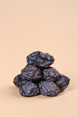 Dried Tianshan Plums Stack on Beige Background - Healthy Snack Food Display