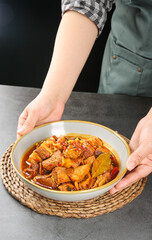 Freshly Braised Beef Brisket Stew with Yellow Vegetable Cubes - Homemade Comfort Food in Ceramic Bowl