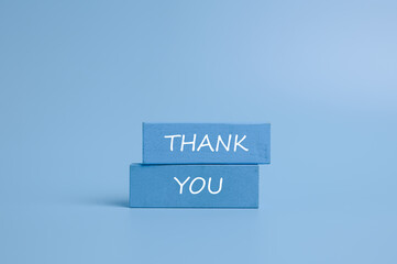 Symbol with word thank you, Wooden block and text on light blue background, Positive communication, Business and thank you concept. copy space	