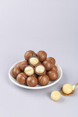 Macadamia Nuts in Bowl with Cracked Shells Showing Kernels - Healthy Snack Food Photography