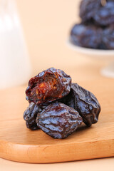 Dried Wild Tianshan Plums Close-up Shot on Wooden Board - Traditional Asian Fruit Snack