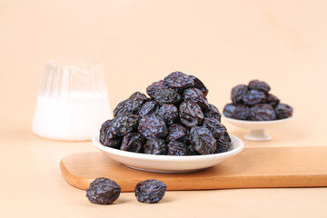 Tianshan Wild Dried Plums in White Dishes on Wooden Board with Milk Glass - Healthy Organic Fruit Snack