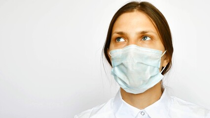A young nurse looking up cheerfully