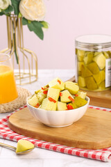 Pickled Mango Cubes with Chili Peppers - Traditional Guangxi Sweet and Sour Preserved Fruit Snack in White Bowl