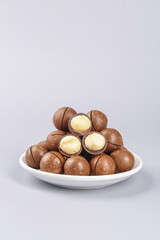 Imported Macadamia Nuts Arranged on White Plate with Shallow Focus Food Photography