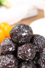 Dried Tianshan Plums from Xinjiang - Sweet and Sour Dehydrated Fruits on Wooden Background
