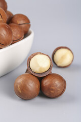 Fresh Macadamia Nuts with Kernels Exposed in White Bowl - Premium Imported Specialty Nuts