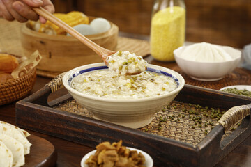 Delicious Mung Bean Porridge Summer Breakfast Bowl with Wooden Spoon and Traditional Setting