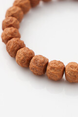 A wooden bead bracelet laid flat, showcasing natural materials and craftsmanship,Irregular walnut surface pattern carving