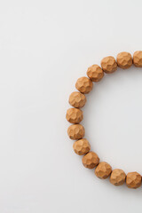 A wooden bead bracelet laid flat, showcasing natural materials and craftsmanship,Polygonal pattern engraving