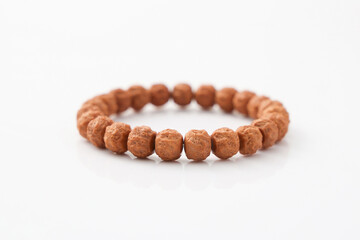 A wooden bead bracelet laid flat, showcasing natural materials and craftsmanship