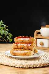 Grilled Herb Sausages Stacked on Plate - Delicious Gourmet Meal on Rustic Kitchen Counter
