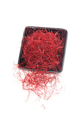 Fototapeta premium Dried Red Chili Pepper Shredded Fine Threads in Black Bowl on White Background