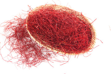 Naklejka premium Dried Red Saffron Threads in Wicker Basket on White Background
