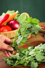 Fresh Wild Ashwagandha Leaves and Organic Vegetables in Kitchen Setting