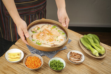 Traditional Chinese Seafood Congee with Mushroom and Shrimp in Clay Pot - Asian Breakfast Rice Porridge