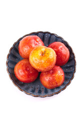 Fresh Red Yellow Plums with Water Drops in Ceramic Bowl White Background