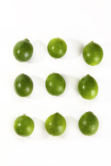Fresh Green Limes Arranged on White Background - Citrus Fruit Pattern