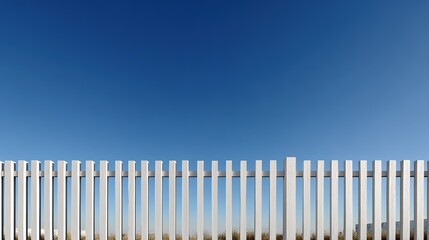 white picket fence with  clear blue sky above white fence wooden fence