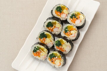 Korean Rolled Gimbap, made of rice, cucumber, tuna, carrot, sausage, crab stick and wrapped with seaweed laver. 
