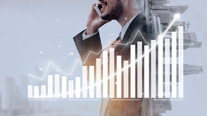 A businessman engages in a phone conversation while surrounded by a digital financial graph, symbolizing growth and success in a modern business environment. Copula