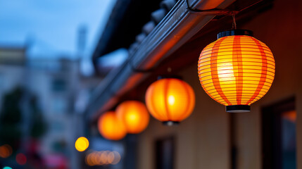 Obraz premium Traditional Japanese red lanterns hanging from a building at dusk during a cultural evening. 