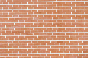 The wall is made of orange bricks, cut with white lines.
