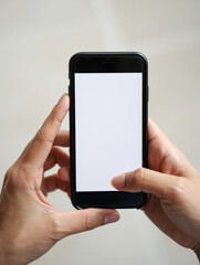 Person holding a black smartphone with a blank white screen displaying in portrait orientation view