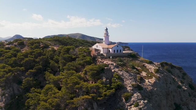 Aerial Drone Shot Approaching Capdepera Lighthouse From The Mediterranean Sea In Cala Gat, Mallorca, Spain.