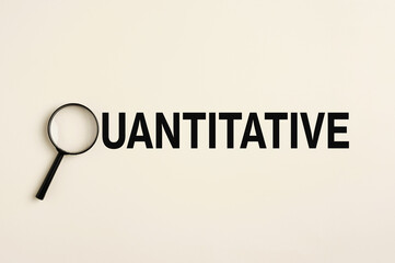 Magnifying glass focusing on quantitative research and analysis