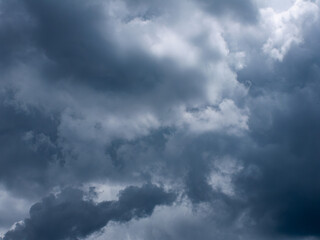 Dramatic dark storm clouds in overcast sky before thunderstorm and heavy rain - moody weather background for climate and meteorology concepts.