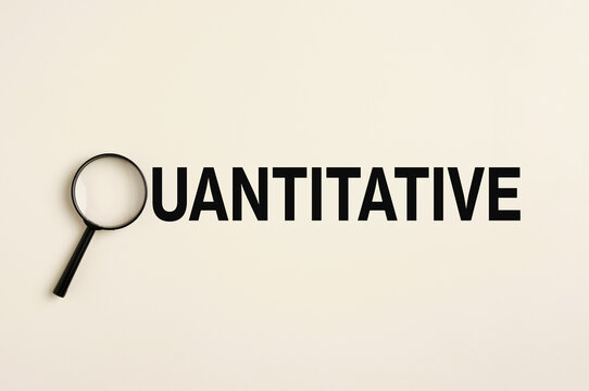 Magnifying glass focusing on quantitative research and analysis