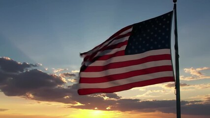 American flag waving in the wind against a golden sunset sky