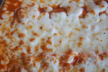 Cheese bubbling on a hot dish in a rustic kitchen