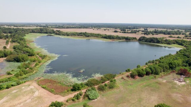 Aerial video of the Wolfe City Reservoir 2 in Wolfe City, Texas. Camera is heading approximately northeast over the reservoir.
