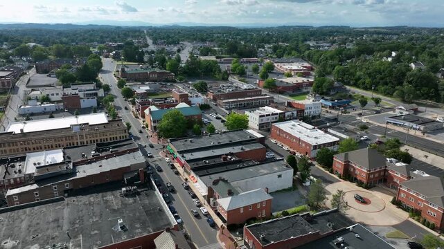 Historic American town ich cars on main streets and square. Red brick buildings on sunny summer day in Virginia state, USA. Aerial top down shot.