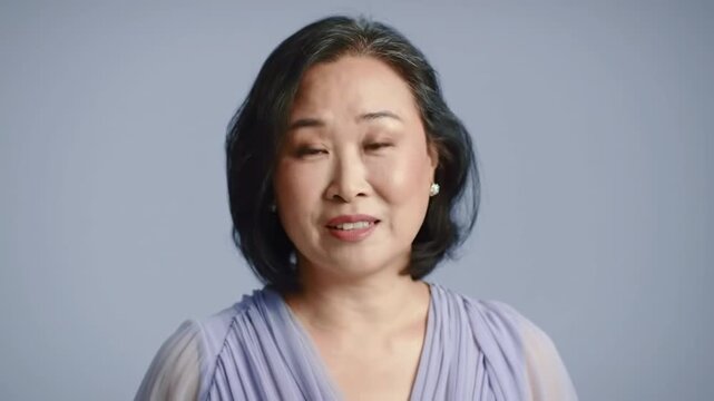 Portrait of a Woman in Lavender Dress Against a Lilac Background