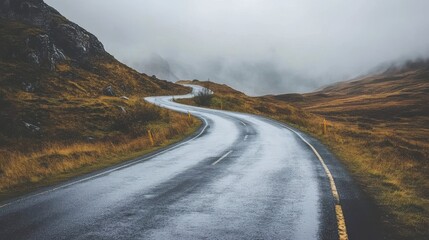 Fototapeta premium Scenic Winding Road Through Misty Mountains Autumn Landscape Travel way fog sky wet path trip view