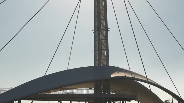 Modern architectural detail with tension cables and steel structure in sunlight