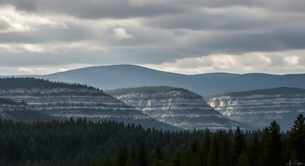 Obraz premium Layered Mountain Ranges, Soft Light, and Dense Forest