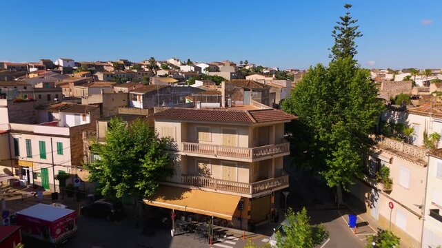 Aerial Drone Shot Flying Over Placa Des Mercat In Maria de la Salut, Mallorca, Spain On A Bright Summer Afternoon.