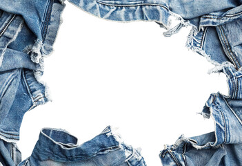 Torn denim fabric frame with frayed blue jeans, isolated on transparent cutout background