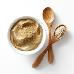 Tan powder in bowl, seeds in spoon, white background