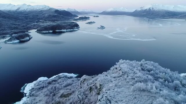 Aerial View of Snowy Mountains and Icy Fjord
