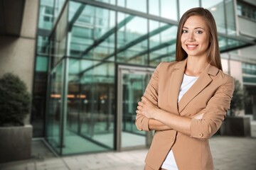 Fototapeta premium Modern stylish business woman standing in work outdoor.
