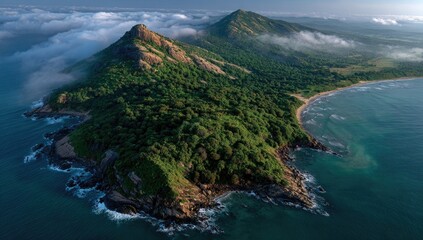 Fototapeta premium Lush, verdant island cape, fringed by a turquoise sea and morning mist