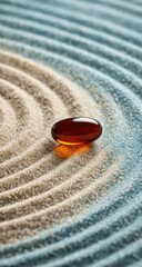 Amber capsule on a zen sand garden