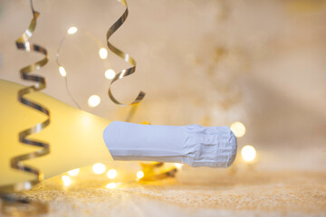 New Year concept, with bright light and champagne bottle, abstract bokeh background